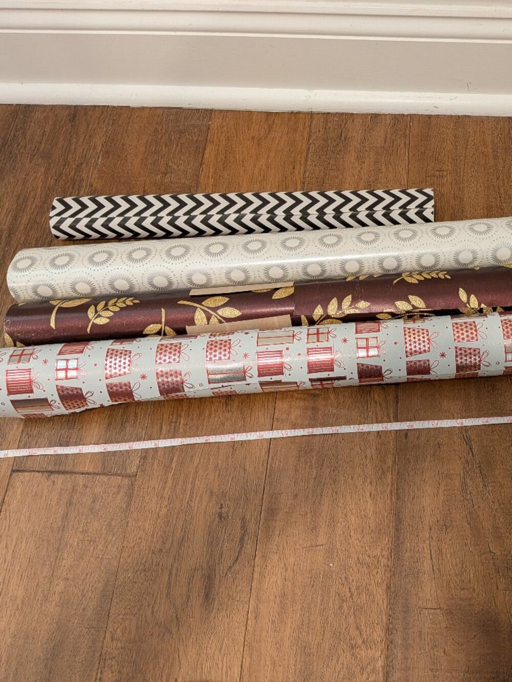 four partial rolls of wrapping paper